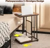 A C-shaped side table with a scratching post and cushion is placed next to a bed. Produktbild-Vorschau