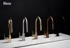 Five kitchen faucets of different colors are displayed on a white surface against a black background. Anteprima dell’immagine prodotto