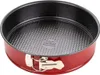 A red springform cake pan with a black interior is shown from a slightly elevated angle against a white background. Produktbild-Vorschau