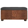 A front view of a brown woven storage bench with a black tufted cushion and dark wooden feet, isolated on a white background. Podgląd zdjęcia produktu