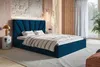 A bedroom scene with a blue upholstered bed as the main focus. Náhled obrázku produktu