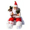 A decorative Santa Claus figurine sitting on books. Náhľad obrázku produktu