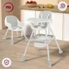 Two high chairs are shown in a kitchen setting with strawberries and a lemon on the counter. Podgląd zdjęcia produktu