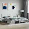 A bedroom scene featuring a white metal bed frame with abstract art on the wall. Produktbild-Vorschau