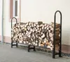 A metal firewood rack filled with chopped wood is placed on a paved outdoor area next to a building. Náhľad obrázku produktu