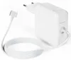 A white Apple Macbook charger with its cable coiled next to it, on a white background. Produktbild-Vorschau