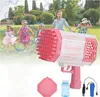 Pink-weiße Bazooka-Blasenpistole mit einer Flasche Lösung, einem Tablett und einem wiederaufladbaren Akku mit Ladekabel, gezeigt mit Kindern, die in einem Park mit Blasen spielen Voir les images du produit