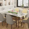 A dining table set up for a meal in a well-lit dining room with a window overlooking a city. Produktbild-Vorschau