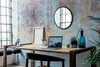 A desk setup with a laptop, plants, and decorative items against a textured wall. Produktbild-Vorschau