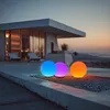 Three illuminated spherical solar lights are placed on a gravel surface in front of a modern house at dusk. Anteprima dell’immagine prodotto