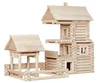 A wooden toy log cabin construction set with a separate smaller structure and fence. Anteprima dell’immagine prodotto