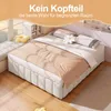 A bed without a headboard is shown in a room with natural light coming from a window. Anteprima dell’immagine prodotto
