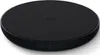 A black wireless charging pad is shown from a slightly elevated angle against a white background. Produktbild-Vorschau