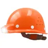 An orange construction helmet with a built-in LED light and adjustable strap, shown against a white background. Produktbild-Vorschau