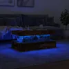 A dark living room scene with a couch, coffee table, and plant. Voir les images du produit