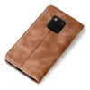 A brown flip cover case for a smartphone is shown from a slightly elevated angle against a white background. Produktbild-Vorschau