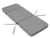 A gray chaise lounge cushion with black trim and ties, shown against a white background. Produktbild-Vorschau