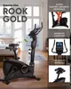 An exercise bike is shown in a room with a bed and window, with feature callouts on the right side. Produktbild-Vorschau