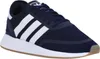A close-up, side view of a navy blue Adidas sneaker with white stripes. Podgląd zdjęcia produktu