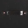 A close-up of a sawtooth picture hanger attached to a black surface. Náhľad obrázku produktu