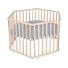 A hexagonal wooden playpen with a grey and white striped mat inside, shown on a white background. Produktbild-Vorschau