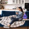 A woman is sitting on a couch in a modern kitchen, using her phone and wearing headphones. An aroma diffuser is on a coffee table in front of her. Voir les images du produit