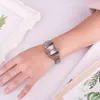 A person's arm wearing a silver Casio watch, with decorative frames and plants in the background. Produktbild-Vorschau