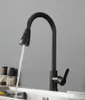 A black kitchen faucet with water running into a sink. Produktbild-Vorschau