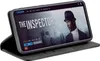 A smartphone in a black flip case is displayed, showing a movie streaming interface on its screen. Produktbild-Vorschau