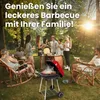 A family is enjoying a barbecue in a backyard setting. Produktbild-Vorschau