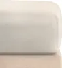 A close-up view of a beige fitted sheet on top of another beige fabric surface. Produktbild-Vorschau