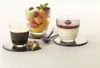 Three glasses of dessert and coffee are arranged on a table with a white tablecloth. Voir les images du produit