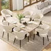 A dining room scene with a wooden table and chairs, a sofa in the background, and large windows. Voir les images du produit