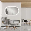 A modern living room with a chair, ottoman, and a large oval mirror with LED lighting. Anteprima dell’immagine prodotto