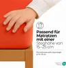 A child's hand rests on an orange fabric, likely a fitted sheet, with text and icons indicating product specifications. Produktbild-Vorschau