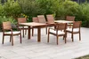 A wooden garden furniture set including a table and chairs on a patio with greenery in the background. Produktbild-Vorschau