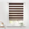 A window with brown and white striped roller blinds. Produktbild-Vorschau