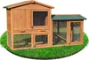 A wooden rabbit hutch with an attached run, situated on a patch of green grass. Produktbild-Vorschau