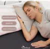 A woman sleeping on a bed with a pillow. Produktbild-Vorschau