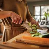 A person is chopping cucumbers in a kitchen. Podgląd zdjęcia produktu
