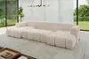 A modern living room with a large U-shaped sectional sofa in beige, placed on a light-colored rug. Large windows with sheer curtains reveal a lush green garden outside. Produktbild-Vorschau