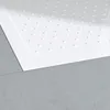 A close-up view of a white shower tray with raised dots, placed on a gray textured surface. Produktbild-Vorschau