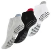 Three pairs of low-cut socks with grip dots on the soles, arranged diagonally. Produktbild-Vorschau