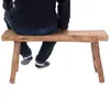 A person sitting on a wooden bench. Produktbild-Vorschau