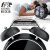 A man sleeping in bed with a digital alarm clock on a nightstand. Náhled obrázku produktu