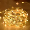 A close-up shot of a coiled string of warm white LED lights. Produktbild-Vorschau