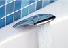 A close-up shot of a modern bathtub faucet with water flowing out. Náhľad obrázku produktu