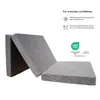 A folded gray mattress against a white background, with informational text and a logo on the right. Podgląd zdjęcia produktu