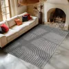 A living room scene with a sofa, fireplace, and a rug. Voir les images du produit
