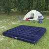 Camping scene with an air mattress, tent, chairs, and sleeping bags on grass. Náhled obrázku produktu
